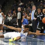 
              Memphis' Earl Timberlake (0) and St. Louis' Yuri Collins (1) battle for the ball in the first half of an NCAA college basketball game Tuesday, Nov. 16, 2021, in Memphis, Tenn. (AP Photo/Karen Pulfer Focht)
            