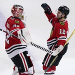 
              Chicago Blackhawks left wing Alex DeBrincat, right, celebrates with goaltender Kevin Lankinen after scoring the game-winning goal against the Nashville Predators during an overtime period of an NHL hockey game in Chicago, Sunday, Nov. 7, 2021. The Chicago Blackhawks won 2-1 in overtime. (AP Photo/Nam Y. Huh)
            