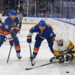 
              Pittsburgh Penguins Evan Rodrigues (9) battles for control of the puck against the New York Islanders' Matt Martin (17) and Cal Clutterbuck (15) in the third period of an NHL hockey game, Friday, Nov. 26, 2021, in Elmont, N.Y. (AP Photo/Eduardo Munoz Alvarez)
            