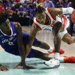 
              Seton Hall guard Kadary Richmond, left, falls to court after fouling Ohio State guard Meechie Johnson Jr. during the second half of an NCAA college basketball game Monday, Nov. 22, 2021, in Fort Myers, Fla. (AP Photo/Scott Audette)
            