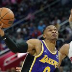 
              Los Angeles Lakers guard Russell Westbrook (0) drives to the basket as Detroit Pistons forward Trey Lyles (8) defends during the first half of an NBA basketball game, Sunday, Nov. 21, 2021, in Detroit. (AP Photo/Carlos Osorio)
            