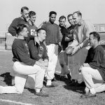 
              FILE - Defensive backfield coach Tom Landry holds ball as New York Giant defensive players huddle Nov. 6, 1958, during workout at Yankee Stadium in New York. Kneeling are, from left, linebacker Harland Svare, middle guard Sam Huff and back Cliff Livingston. Standing, from left, are backs Carl Karilivacz, Jim Patton, Emlen Tunnell, linebacker Bill Svoboda, back Lindon Crow and Landry. Huff, the hard-hitting Hall of Fame linebacker who helped the Giants reach six NFL title games from the mid-1950s to the early 1960s and later became a popular player and announcer in Washington, died Saturday, Nov. 13, 2021. He was 87. (AP Photo/John Lindsay, File)
            