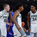 
              Michigan State's A.J. Hoggard, center, celebrates with teammates Joey Hauser (10) and Julius Marble II (34) during the first half of an NCAA basketball game against Kansas Tuesday, Nov. 9, 2021, in New York. (AP Photo/Frank Franklin II)
            