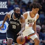 
              Brooklyn Nets guard James Harden (13) moves the ball down court past New Orleans Pelicans center Jaxson Hayes in the first half of an NBA basketball game in New Orleans, Friday, Nov. 12, 2021. (AP Photo/Gerald Herbert)
            