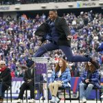 
              Former New York Giants player Michael Strahan jumps in the air during a halftime ceremony at an NFL football game between the New York Giants and the Philadelphia Eagles, Sunday, Nov. 28, 2021, in East Rutherford, N.J. (AP Photo/Corey Sipkin)
            