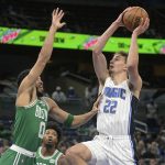 
              Orlando Magic forward Franz Wagner (22) goes up for a shot in front of Boston Celtics forward Jayson Tatum (0) during the first half of an NBA basketball game Wednesday, Nov. 3, 2021, in Orlando, Fla. (AP Photo/Phelan M. Ebenhack)
            