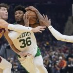 
              Boston Celtics' Marcus Smart (36) drives between Cleveland Cavaliers' Cedi Osman (16) and Darius Garland (10) in the first half of an NBA basketball game, Monday, Nov. 15, 2021, in Cleveland. (AP Photo/Tony Dejak)
            