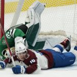
              Dallas Stars goaltender Jake Oettinger (29) is hit by Colorado Avalanche right wing Nicolas Aube-Kubel (16) during the second period of an NHL hockey game in Dallas, Friday, Nov. 26, 2021. Oettinger left the game. (AP Photo/LM Otero)
            