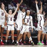 
              South Carolina guard Destanni Henderson (3) and her teammates react to her 3-pointer during the second half of an NCAA college basketball game against Clemson on Wednesday, Nov. 17, 2021, in Columbia, S.C. South Carolina won 76-45. (AP Photo/Sean Rayford)
            
