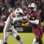 
              South Carolina running back ZaQuandre White (11) runs with the ball against Auburn cornerback Jaylin Simpson (36) during the first half of an NCAA college football game Saturday, Nov. 20, 2021, in Columbia, S.C. (AP Photo/Sean Rayford)
            