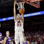 
              Arkansas forward Connor Vanover (23) dunks the ball on a fast break in front of Northern Iowa's Cole Henry (1), AJ Green (4) and Bowen Born (13) during the first half of an NCAA college basketball game Wednesday, Nov. 17, 2021, in Fayetteville, Ark. (AP Photo/Michael Woods)
            