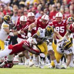 
              Iowa's Tyler Goodson (15) carries the ball as Nebraska's Marquel Dismuke (9) dives for the tackle during the first half of an NCAA college football game, Friday, Nov. 26, 2021, at Memorial Stadium in Lincoln, Neb. (AP Photo/Rebecca S. Gratz)
            