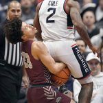 
              Connecticut's R.J. Cole, right, fouls Maryland-Eastern Shore's Dom London during the first half of an NCAA college basketball game, Tuesday, Nov. 30, 2021, in Hartford, Conn. (AP Photo/Jessica Hill)
            