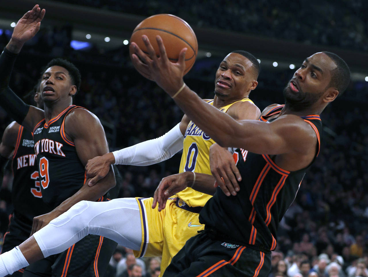 Los Angeles Lakers guard Russell Westbrook (0) and New York Knicks guard Alec Burks (18) vie for a ...