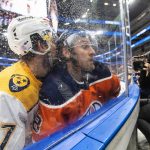 
              Nashville Predators' Dante Fabbro (57) checks Edmonton Oilers' Kyle Turris (8) during the second period of an NHL hockey game Wednesday, Nov. 3, 2021, in Edmonton, Alberta. (Jason Franson/The Canadian Press via AP)
            