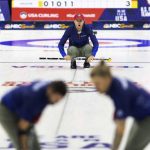 
              Team Shuster's John Shuster, center, yells to teammates John Landsteiner, left, and Matt Hamilton as they sweep during a match against Team Dropkin at the U.S. Olympic curling team trials at Baxter Arena in Omaha, Neb., Friday, Nov. 19, 2021. (AP Photo/Rebecca S. Gratz)
            