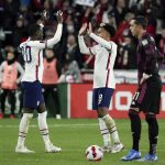 
              U.S. midfielder Weston McKennie, center, celebrates with teammate Tim Weah (20) after scoring a goal during the second half of the team's FIFA World Cup qualifying soccer match against Mexico, Friday, Nov. 12, 2021, in Cincinnati. (AP Photo/Jeff Dean)
            