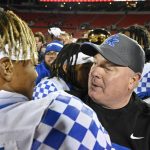 
              Kentucky head coach Mark Stoops, right, congratulates defensive back Carrington Valentine after their victory over Louisville in an NCAA college football game in Louisville, Ky., Saturday, Nov. 27, 2021. (AP Photo/Timothy D. Easley)
            