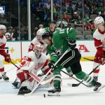 
              Dallas Stars center Joe Pavelski (16) attempts to control the puck in front of the net as Detroit Red Wings' Alex Nedeljkovic (39), Danny DeKeyser (65), Tyler Bertuzzi (59) and Moritz Seider (53) defend in the first period of an NHL hockey game in Dallas, Tuesday, Nov. 16, 2021. (AP Photo/Tony Gutierrez)
            