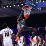 
              In this photo provided by Bahamas Visual Services, Baylor forward Jonathan Tchamwa Tchatchoua (23) hangs from the rim after dunking against Virginia Commonwealth during an NCAA college basketball game at Paradise Island, Bahamas, Thursday, Nov. 25, 2021. (Tim Aylen/Bahamas Visual Services via AP)
            