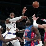 
              Los Angeles Lakers forward LeBron James, second form left, passes the ball away from Detroit Pistons forward Jerami Grant, left, and center Isaiah Stewart (28) during the first half of an NBA basketball game Sunday, Nov. 28, 2021, in Los Angeles. (AP Photo/Alex Gallardo)
            