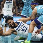 
              Minnesota Timberwolves center Karl-Anthony Towns (32) scrambles for the ball against Charlotte Hornets forward P.J. Washington (25) during the first half of an NBA basketball game in Charlotte, N.C., Friday, Nov. 26, 2021. (AP Photo/Jacob Kupferman)
            