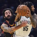 
              Cleveland Cavaliers' Ricky Rubio, left, tries to knock the ball loose from Brooklyn Nets' DeAndre' Bembry (95) during the first half of an NBA basketball game Monday, Nov. 22, 2021, in Cleveland. (AP Photo/Tony Dejak)
            