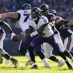 
              Baltimore Ravens quarterback Tyler Huntley pitches the ball out to Devonta Freeman during the first half of an NFL football game against the Chicago Bears Sunday, Nov. 21, 2021, in Chicago. (AP Photo/Nam Y. Huh)
            