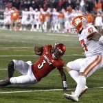 
              Louisville quarterback Malik Cunningham (3) slips in front Clemson linebacker James Skalski (47) and defensive end Xavier Thomas (3) as he attempts to score on the last play an NCAA college football game in Louisville, Ky., Saturday, Nov. 6, 2021. Clemson won 30-24. (AP Photo/Timothy D. Easley)
            