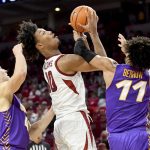 
              Arkansas forward Jaylin Williams (10) is fouled as he tries to drive past Northern Iowa defenders AJ Green (4) and Trae Berhow (11) during the first half of an NCAA college basketball game Wednesday, Nov. 17, 2021, in Fayetteville, Ark. (AP Photo/Michael Woods)
            