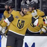 
              Vegas Golden Knights defenseman Shea Theodore (27) is congratulated after his goal against the Seattle Kraken during the third period of an NHL hockey game Tuesday, Nov. 9, 2021, in Las Vegas. (AP Photo/David Becker)
            