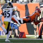 
              Cincinnati Bengals wide receiver Tyler Boyd (83) makes a diving catch past Pittsburgh Steelers cornerback Arthur Maulet (35) during the first half of an NFL football game, Sunday, Nov. 28, 2021, in Cincinnati. (AP Photo/Jeff Dean)
            