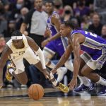
              Sacramento Kings guard Buddy Hield (24) and New Orleans Pelicans guard Kira Lewis Jr. (13) chase down a loose ball during the first quarter of an NBA basketball game in Sacramento, Calif., Wednesday, Nov. 3, 2021. (AP Photo/José Luis Villegas)
            
