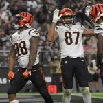 
              Cincinnati Bengals wide receiver Ja'Marr Chase (1) and tight end C.J. Uzomah (87) celebrate after running back Joe Mixon (28) scored a touchdown against the Las Vegas Raiders during the second half of an NFL football game, Sunday, Nov. 21, 2021, in Las Vegas. (AP Photo/David Becker)
            