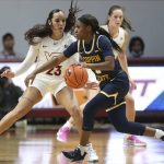 
              Coppin State's Aliyah Lawson (3) drives a Virginia Tech's Kayana Traylor (23) defends during in the first half of an NCAA college basketball game in Blacksburg Va., Wednesday, Nov. 17 2021. (Matt Gentry/The Roanoke Times via AP)
            
