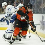 
              Anaheim Ducks' Hampus Lindholm, right, moves the puck past Toronto Maple Leafs' John Tavares during the first period of an NHL hockey game Sunday, Nov. 28, 2021, in Anaheim, Calif. (AP Photo/Jae C. Hong)
            