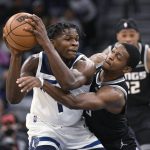 
              Sacramento Kings guard De'Aaron Fox, right, tries to slap the ball away from Minnesota Timberwolves guard Anthony Edwards during the second half of an NBA basketball game Wednesday, Nov. 17, 2021, in Minneapolis. The Timberwolves won 107-97. (AP Photo/Craig Lassig)
            