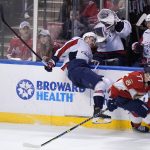 
              Florida Panthers center Frank Vatrano (77) slams Washington Capitals left wing Beck Malenstyn into the boards during the first period of an NHL hockey game, Tuesday, Nov. 30, 2021, in Sunrise, Fla. (AP Photo/Wilfredo Lee)
            