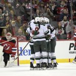 
              Minnesota Wild right wing Ryan Hartman (38) is surrounded by teammates after scoring a goal against New Jersey Devils goaltender Mackenzie Blackwood, left, during the first period of an NHL hockey game Wednesday, Nov. 24, 2021, in Newark, N.J. (AP Photo/Bill Kostroun)
            