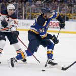 
              St. Louis Blues' David Perron (57) tries to shoot as Edmonton Oilers' Ryan Nugent-Hopkins (93) defends during the second period of an NHL hockey game Sunday, Nov. 14, 2021, in St. Louis. (AP Photo/Jeff Roberson)
            