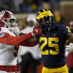 
              Michigan running back Hassan Haskins (25) is pushed out of bounds by Indiana defensive back Marcelino McCrary-Ball (9) after a 62-yard rush during the first half of an NCAA college football game against Indiana, Saturday, Nov. 6, 2021, in Ann Arbor, Mich. (AP Photo/Carlos Osorio)
            