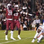 
              South Carolina defensive back Darius Rush (28) and David Spaulding (29) celebrate a play during the second half of an NCAA college football game against Auburn, Saturday, Nov. 20, 2021, in Columbia, S.C. (AP Photo/Sean Rayford)
            