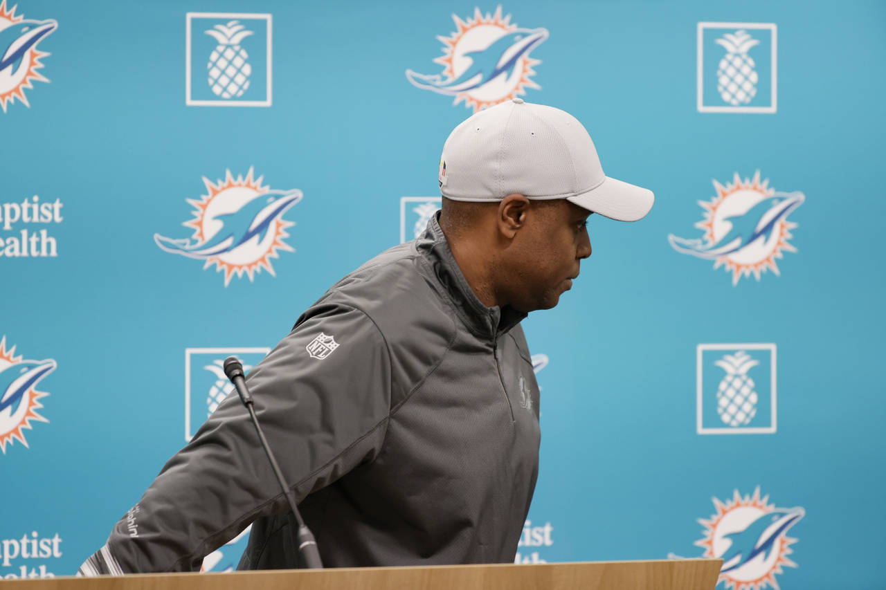 Miami Dolphins general manager Chris Grier leaves the podium after talking to the media before prac...