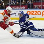 
              Calgary Flames' Oliver Kylington (58) scores on Toronto Maple Leafs goaltender Jack Campbell (36) during the third period of an NHL hockey game in Toronto on Friday, Nov. 12, 2021. (Frank Gunn/The Canadian Press via AP)
            