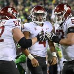 
              Washington State quarterback Jayden de Laura (4) celebrates his touchdown with offensive lineman Jarrett Kingston (52) and offensive lineman Liam Ryan (63) during the second quarter of an NCAA college football game Saturday, Nov. 13, 2021, in Eugene, Ore. (AP Photo/Andy Nelson)
            