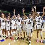 
              FILE - In this March 6, 2020, file photo, South Carolina players celebrate after defeating Georgia 89-56 in a quarterfinal match at the Southeastern women's NCAA college basketball tournament in Greenville, S.C. Dawn Staley and South Carolina are back in a familiar spot: No. 1 in The Associated Press Top 25 women's basketball poll, released Tuesday, Oct. 19, 2021.(AP Photo/Richard Shiro, File)
            