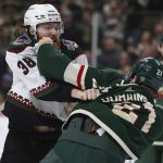 
              Arizona Coyotes center Liam O'Brien (38) and Minnesota Wild right wing Brandon Duhaime (21) fight during the second period of an NHL hockey game Tuesday, Nov. 30, 2021, in St. Paul, Minn. (AP Photo/Stacy Bengs)
            
