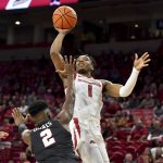 
              Arkansas guard JD Notae (1) shoots over Pennsylvania guard Jonah Charles (2) during the first half of an NCAA college basketball game Sunday, Nov. 28, 2021, in Fayetteville, Ark. (AP Photo/Michael Woods)
            