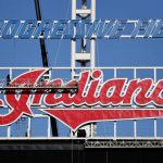 
              Workers begin to remove the Cleveland Indians sign from above the scoreboard at Progressive Field, Tuesday, Nov. 2, 2021, in Cleveland. Known as the Indians since 1915, Cleveland's Major League Baseball team will be called Guardians. (AP Photo/Ron Schwane)
            