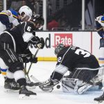 
              Los Angeles Kings goaltender Jonathan Quick, center, blocks a shot by St. Louis Blues left wing Brandon Saad, left left, during the first period of an NHL hockey game Wednesday, Nov. 3, 2021, in Los Angeles. (AP Photo/Kyusung Gong)
            